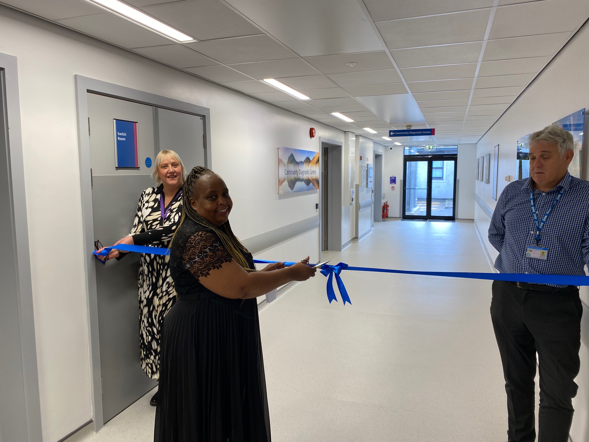 Tabetha Darmon, Chief Nursing Officer, opening the new Clinical Diagnostics Centre at Westmorland General Hospital by cutting a blue ribbon