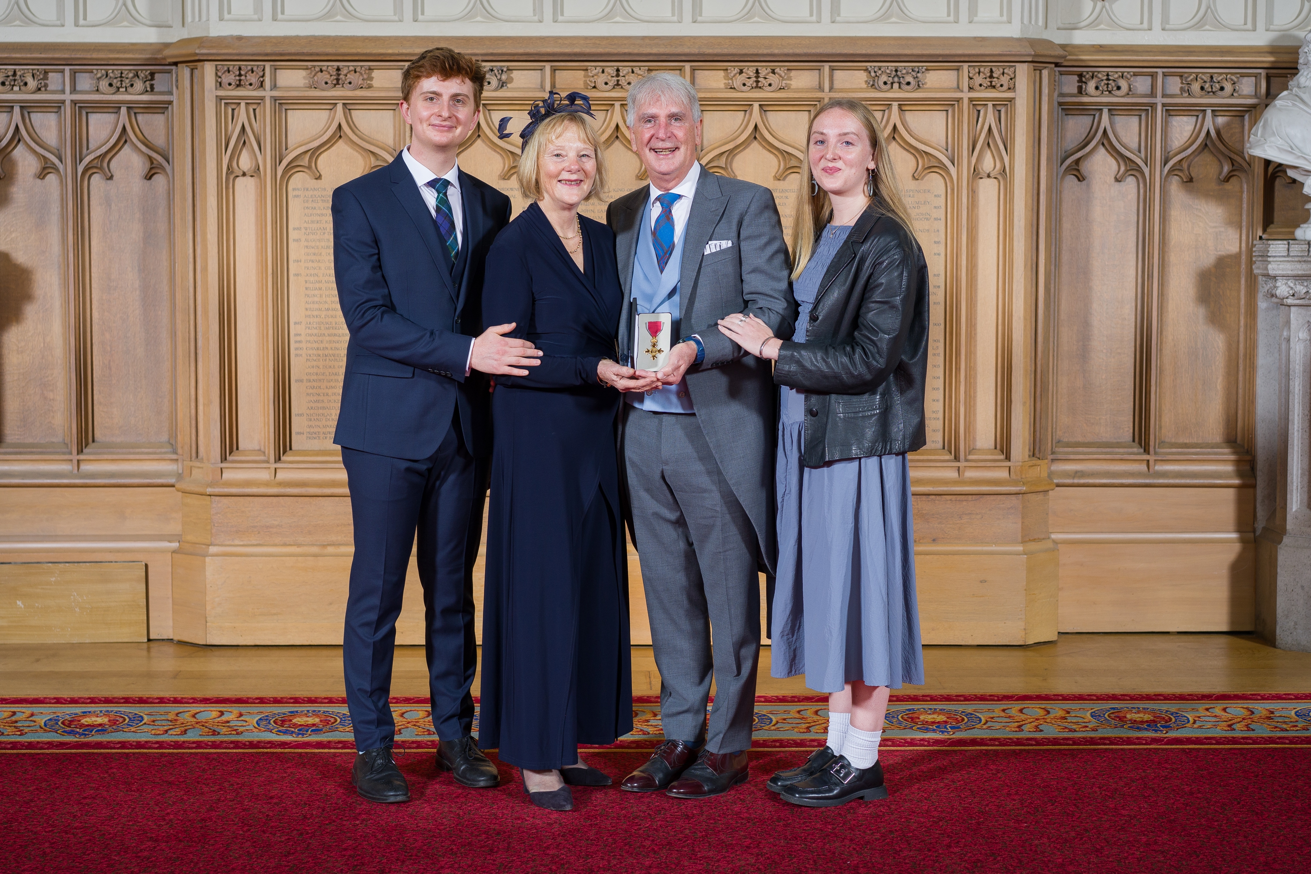 Peter Dyer with his wife Vicky, son Richard and daughter Katherine receiving OBE